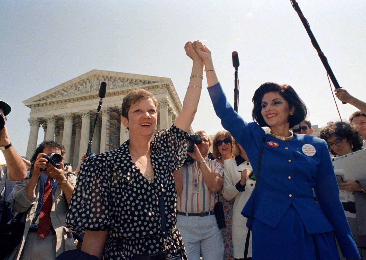 FILE - Norma McCorvey, Jane Roe in the 1973 court case, left, and her attorney Gloria Allred hold h...