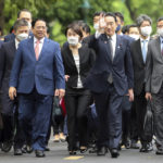 
              Japanese Prime Minister Fumio Kishida, center right, and Vietnamese Prime Minister Pham Minh Chinh, center left, walk in the Presidential Palace in Hanoi, Vietnam on Sunday, May 1, 2022. (AP Photo/Hoang Minh)
            