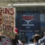 
              People gather outside the George R. Brown Convention Center to protest the National Rifle Association's annual meeting in Houston, Friday, May 27, 2022. (AP Photo/Jae C. Hong)
            