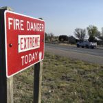 
              A fire warning sign is pictured in Las Vegas, N.M., on Tuesday, May 3, 2022. Flames raced across more of New Mexico's pine-covered mountainsides, Tuesday, May 3, 2030, charring more than 217 square miles over the last several weeks. (AP Photo/Thomas Peipert)
            