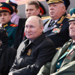 
              Russian President Vladimir Putin, center, attends the Victory Day military parade marking the 77th anniversary of the end of World War II in Moscow, Russia, Monday, May 9, 2022. (Mikhail Metzel, Sputnik, Kremlin Pool Photo via AP)
            