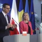 
              Polish Prime Minister, Mateusz Morawiecki, left, Prime Minister of Sweden, Magdalena Andersson and President of the European Commission, center, and Ursula von der Leyen, right, attend the press conference after the High-Level International Donor's Conference for Ukraine at the National Stadium in Warsaw, Poland, Thursday, May 5, 2022. The conference aims to raise funds for Ukraine's growing humanitarian needs. Poland and Sweden want to encourage their partners to jointly respond to the difficult humanitarian situation in Ukraine. (AP Photo/Michal Dyjuk)
            