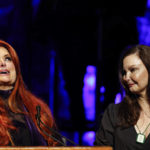 
              Wynonna Judd, left, looks to the sky as sister Ashley Judd watches during the Medallion Ceremony at the Country Music Hall Of Fame Sunday, May 1, 2022, in Nashville, Tenn. (Photo by Wade Payne/Invision/AP)
            