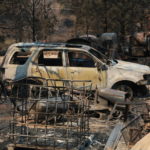 
              A burned car and piece of machinery are seen following a wildfire near Las Vegas, New Mexico, on Monday, May 2, 2022. Wind-whipped flames are marching across more of New Mexico's tinder-dry mountainsides, forcing the evacuation of area residents and dozens of patients from the state's psychiatric hospital as firefighters scramble to keep new wildfires from growing. The big blaze burning near the community of Las Vegas has charred more than 217 square miles. (AP Photo/Cedar Attanasio)
            