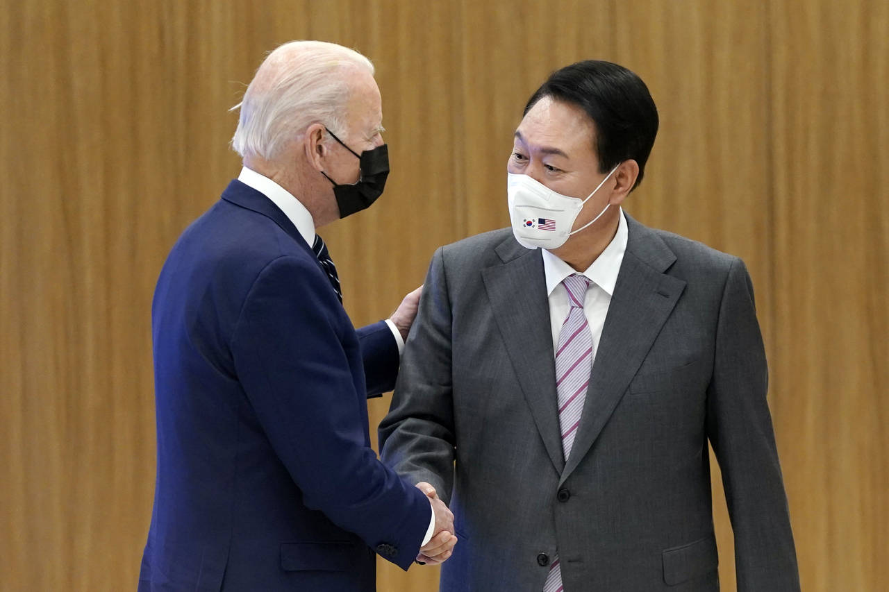 President Joe Biden and South Korean President Yoon Suk Yeol shake hands as they visit the Samsung ...