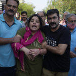 
              Meenakshi mourns during the cremation of her husaband Rahul Bhat, a government employee killed on Thursday, in Jammu, India, Friday, May 13, 2022. Bhat, who was a minority Kashmiri Hindu known as "pandits," was killed by suspected rebels inside his office in Chadoora town in the Indian portion of Kashmir. (AP Photo/Channi Anand)
            