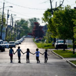 
              Children walk hand in hand out near the scene of a shooting at a supermarket in Buffalo, N.Y., Sunday, May 15, 2022. (AP Photo/Matt Rourke)
            