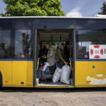 
              People stand in the bus during evacuation near Lyman, Ukraine, Wednesday, May 11, 2022. (AP Photo/Evgeniy Maloletka)
            