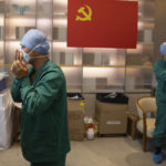 
              In this photo released by Xinhua News Agency, health workers from Tianjin wear protective suits at the headquarters of a medical emergency team sent to assist Shanghai on May 9, 2022. Shanghai reaffirmed China's strict "zero-COVID" approach to pandemic control Wednesday, a day after the head of the World Health Organization said that was not sustainable and urged China to change strategies. (Jin Liwang/Xinhua via AP)
            