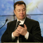 
              FILE - Elon Musk founder, CEO, and chief engineer/designer of SpaceX jokes with reporters as he pretends to search for an answer to a question on a cell phone during a news conference after a Falcon 9 SpaceX rocket test flight to demonstrate the capsule's emergency escape system at the Kennedy Space Center in Cape Canaveral, Fla., Sunday, Jan. 19, 2020.  Many people are puzzled on what a Elon Musk takeover of Twitter would mean for the company and even whether he’ll go through with the deal.  If the 50-year-old Musk’s gambit has made anything clear it’s that he thrives on contradiction. (AP Photo/John Raoux, File)
            