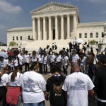 
              People pray outside of the U.S. Supreme Court Tuesday, May 3, 2022 in Washington. A draft opinion suggests the U.S. Supreme Court could be poised to overturn the landmark 1973 Roe v. Wade case that legalized abortion nationwide, according to a Politico report released Monday. Whatever the outcome, the Politico report represents an extremely rare breach of the court's secretive deliberation process, and on a case of surpassing importance. (AP Photo/Jose Luis Magana)
            