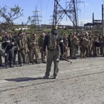 
              In this photo taken from video released by the Russian Defense Ministry Press Service on Wednesday, May 18, 2022, Ukrainian servicemen stand in font of a Russian serviceman after they leaved the besieged Azovstal steel plant in Mariupol, Ukraine.(Russian Defense Ministry Press Service via AP)
            