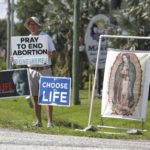 
              Dave Behrle, 70, of Safety Harbor holds a sign while standing outside the All Women's Health Center of Clearwater on Tuesday, May 3, 2022. A draft of a U.S. Supreme Court brief was leaked Monday that suggests the court could be poised to overturn the landmark 1973 Roe v. Wade case. (Chris Urso/Tampa Bay Times via AP)
            