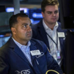 
              In this photo provided by the New York Stock Exchange, specialist Dilip Patel, left, works at his post on the floor, Monday, May 16, 2022. Stocks fell in morning trading on Wall Street Monday, continuing a losing streak that has brought the market down for six weeks in a row. (Courtney Crow/New York Stock Exchange via AP)
            