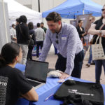 
              Hannah Niapas talks to Rodrigo Zuniga about job opportunities at Blockchain.com, during the Venture Miami Tech Hiring Fair Thursday, April 14, 2022, in Miami. America’s employers added 428,000 jobs in April, extending a streak of solid hiring that has defied punishing inflation, chronic supply shortages, the Russian war against Ukraine and much higher borrowing costs.  (AP Photo/Marta Lavandier)
            