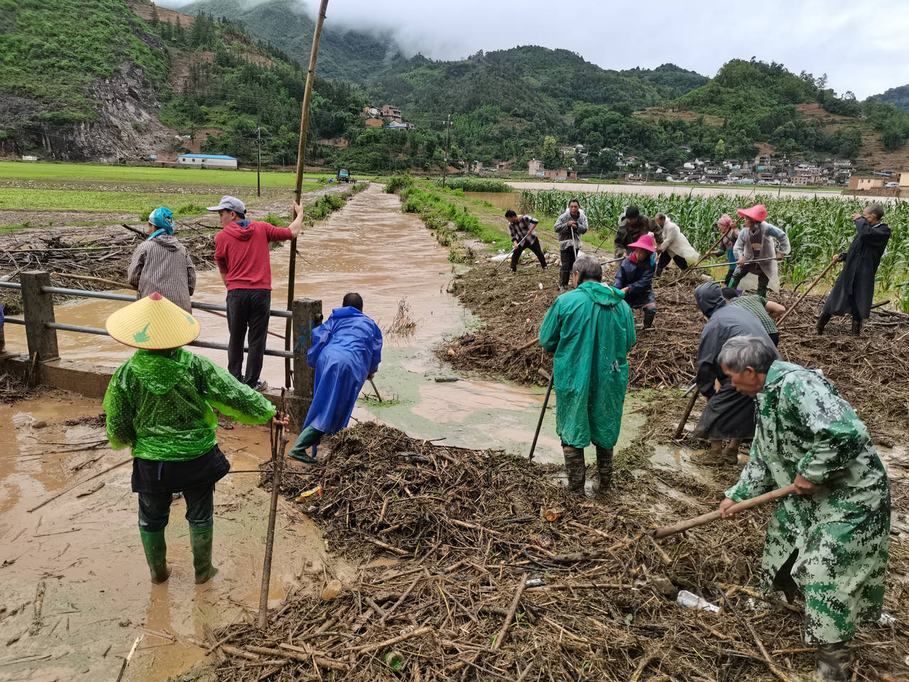 In this photo released by China's Xinhua News Agency, people work in a flooded area in Qiubei Count...