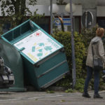 
              View of an overturned used clothing container in Lippstadt, Germany, Friday, May 20, 2022. In the background is a downed tree. Meteorologists had warned that heavy rainfall and hail were expected in western and central Germany on Friday, with storms producing wind gusts up to 130 kph (81 mph). (Friso Gentsch/dpa via AP)
            