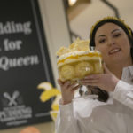 
              Jemma Melvin the Platinum Jubilee Pudding winner poses for the media with her creation, at a department store in London, Friday, May 13, 2022. Jemma was chosen from over 5000, entries. The 31-year-old copywriter's seven-layer lemon Swiss roll and amaretti trifle beat 5,000 desserts in a U.K.-wide competition to become the official pudding — or dessert, if you’re not British — of the Queen’s Platinum Jubilee. (AP Photo/Alastair Grant)
            