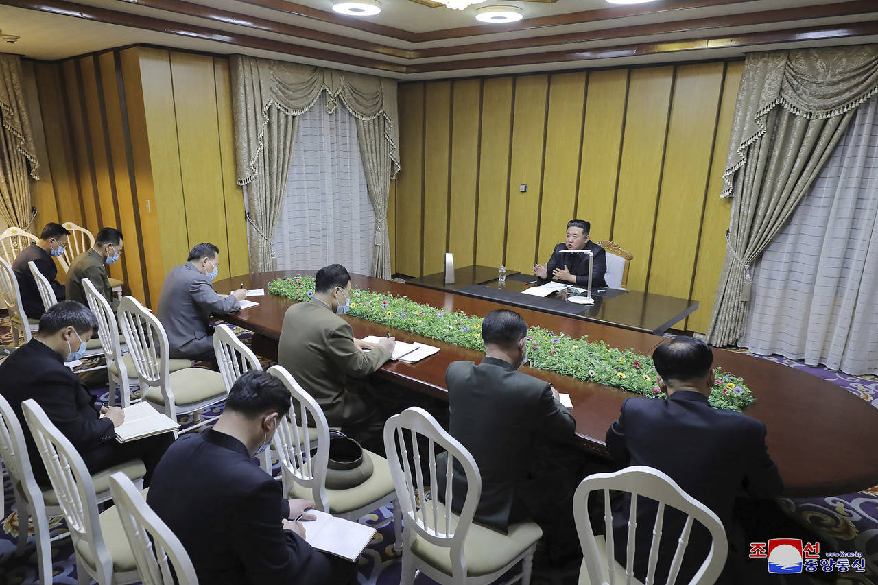 In this photo provided by the North Korean government, North Korean leader Kim Jong Un, top, visits...