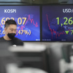 
              A currency trader walks by the screens showing the Korea Composite Stock Price Index (KOSPI), left, and the foreign exchange rate between U.S. dollar and South Korean won at a foreign exchange dealing room in Seoul, South Korea, Wednesday, May 4, 2022. Shares were mostly lower in Asia ahead of a interest rate decision by the Federal Reserve later Wednesday, with markets in China, Japan and some other markets still closed for holidays. (AP Photo/Lee Jin-man)
            