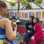 
              Rep. Marie Newman, right, D-Ill., poses for a photograph with supporter Chakena Perry at a campaign fundraiser May 9, 2022, in Chicago. The first-term Democrat is among the women members of the U.S. House of Representatives whose reelection bid grew more difficult due to the drawing of new congressional boundaries, known as redistricting. (AP Photo/Sara Burnett)
            