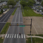 
              A pedestrian crosses at the westbound side of Roosevelt Avenue on at the Banks Way crosswalk, Thursday, May 12, 2022, in Philadelphia. Roosevelt Boulevard is an almost 14-mile maze of chaotic traffic patterns that passes through some of the city's most diverse neighborhoods and Census tracts with the highest poverty rates. Driving can be dangerous with cars traversing between inner and outer lanes, but biking or walking on the boulevard can be even worse with some pedestrian crossings longer than a football field and taking four light cycles to cross. (AP Photo/Julio Cortez)
            