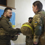 
              In this photo provided by the Ukrainian Presidential Press Office on Sunday, May 29, 2022, Ukrainian President Volodymyr Zelenskyy, left, awards a servicewoman as he visits the war-hit Kharkiv region. Volodymyr Zelenskyy described the situation in the east as "indescribably difficult." The "Russian army is trying to squeeze at least some result" by concentrating its attacks there, he said in a Saturday night video address. (Ukrainian Presidential Press Office via AP)
            