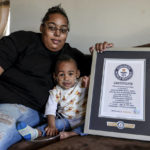 
              Curtis Means and his mother, Michelle Butler, sit with their certificate from the Guinness Book of World Records at their home in Eutaw, Ala., on Wednesday, March 23, 2022. In July 2020, Curtis became the earliest surviving “micropreemie” in the world. (AP Photo/Butch Dill)
            