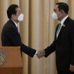 
              Japanese Prime Minister Fumio Kishida, left, shakes hands with Thailand's Prime Minister Prayuth Chan-ocha after a joint press conference at the government house in Bangkok, Thailand, Monday, May 2, 2022. (AP Photo/Sakchai Lalit)
            
