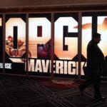 
              An attendee walks past an advertisement for the upcoming film "Top Gun: Maverick" on the opening day of CinemaCon 2022, the official convention of the National Association of Theatre Owners (NATO) at Caesars Palace, Monday, April 25, 2022, in Las Vegas. (AP Photo/Chris Pizzello)
            
