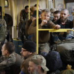 
              Ukrainian servicemen sit in a bus after they were evacuated from the besieged Mariupol's Azovstal steel plant, near a remand prison in Olyonivka, in territory under the government of the Donetsk People's Republic, eastern Ukraine, Tuesday, May 17, 2022. More than 260 fighters, some severely wounded, were pulled from a steel plant on Monday that is the last redoubt of Ukrainian fighters in the city and transported to two towns controlled by separatists, officials on both sides said. (AP Photo/Alexei Alexandrov)
            