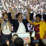 
              Presidential candidate Gustavo Petro, center, and his running mate Francia Marquez, at his right, with the Historical Pact coalition, stand before supporters with Marquez's wife Veronica Alcocer, second from left, and their daughter Andrea on election night in Bogota, Colombia, Sunday, May 29, 2022. Petro will advance to a runoff contest in June after none of the six candidates in Sunday's first round got half the vote. (AP Photo/Fernando Vergara)
            