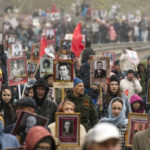 
              People carry portraits of relatives who fought in World War II, during the Immortal Regiment march in Ulan-Ude, the regional capital of Buryatia, a region near the Russia-Mongolia border, Russia, Monday, May 9, 2022, marking the 77th anniversary of the end of World War II. (AP Photo)
            