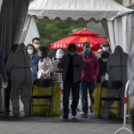 
              People wearing face masks stand in line for COVID-19 tests at a coronavirus testing site in Beijing, Wednesday, May 11, 2022. Shanghai reaffirmed China's strict "zero-COVID" approach to pandemic control Wednesday, a day after the head of the World Health Organization said that was not sustainable and urged China to change strategies. (AP Photo/Mark Schiefelbein)
            