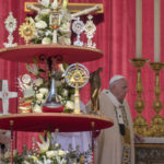 
              Pope Francis walks by the relics of nine new saints as he arrives on the altar in St. Peter's Square at The Vatican, Sunday, May 15, 2022, to celebrate their canonization mass. (AP Photo Gregorio Borgia)
            