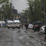
              Red Cross staff drive by in their vehicles to the besieged Mariupol's Azovstal steel plant to observe the evacuation of Ukrainian servicemen from Azovstal steel plant, in Mariupol, in territory under the government of the Donetsk People's Republic, eastern Ukraine, Wednesday, May 18, 2022. (AP Photo)
            