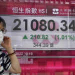 
              A woman wearing a face mask walks past a bank's electronic board showing the Hong Kong share index in Hong Kong, Thursday, May 5, 2022. Asian stock markets followed Wall Street higher on Thursday after the Federal Reserve chairman downplayed the likelihood of bigger rate hikes following the U.S. central bank's biggest increase in two decades. (AP Photo/Kin Cheung)
            