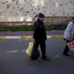 
              Residents walk toward their homes, buildings ruined by shelling in Irpin, outskirts of Kyiv, Ukraine, Tuesday, May 24, 2022. (AP Photo/Natacha Pisarenko)
            