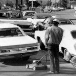 
              FILE - Drivers and a man pushing a lawnmower line up at gas station in San Jose, Calif., on March 15, 1974. An unhappy confluence of events has economists reaching back to the days of disco and the bleak high-inflation, high-unemployment economy of nearly a half century ago. No one thinks stagflation is in sight. But as a longer-term threat, it can no longer be dismissed. (AP Photo/File)
            