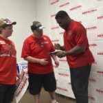 
              Georgia Republican Senate candidate Herschel Walker, right, signs a soda bottle commemorating the 1980 football championship he won with the University of Georgia for Peter Bagarella of Ellerslie, Ga., after a speech at Muscogee County GOP headquarters in Columbus, Ga., Saturday, May 21, 2022. (AP Photo/Jeff Amy)
            