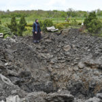 
              Orthodox Sister Evdokia gestures in front of the crater of an explosion, after Russian shelling next to the Orthodox Skete in honour of St. John of Shanghai in Adamivka, near Slovyansk, Donetsk region, Ukraine, Tuesday, May 10, 2022. (AP Photo/Andriy Andriyenko)
            