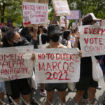 
              Students and activists hold slogans during a rally in front of the office of the Commission on Elections as they question the results of the presidential elections in Manila, Philippines on Tuesday May 10, 2022. The namesake son of late Philippine dictator Ferdinand Marcos appeared to have been elected Philippine president by a landslide in an astonishing reversal of the 1986 "People Power" pro-democracy revolt that booted his father into global infamy. (AP Photo/Aaron Favila)
            