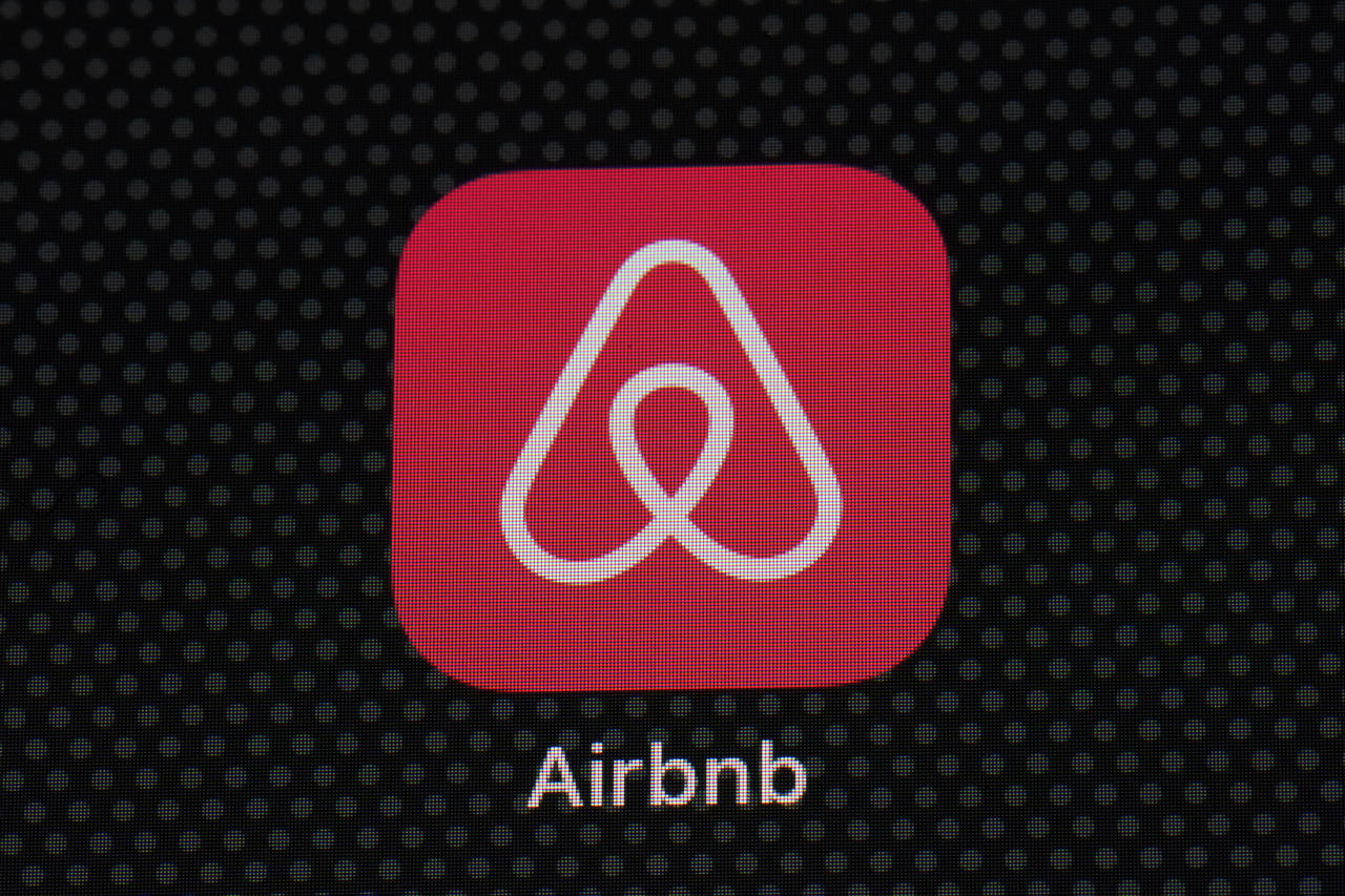 FILE - The Airbnb app icon is seen on an iPad screen, Saturday, May 8, 2021, in Washington.   Airbn...