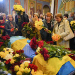 
              People pay their respects during the funeral ceremony for Ukrainian serviceman Ruslan Borovyk killed by the Russian troops in a battle in St Michael cathedral in Kyiv, Ukraine, Wednesday, May 4, 2022. (AP Photo/Efrem Lukatsky)
            