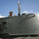 
              A soldier of Donetsk People's Republic militia sits in a self-propelled artillery vehicle 'Gvozdika' ('Carnation') with writing reading 'towards Kyiv!', near the town of Yasynuvataya, outside Donetsk, in territory under the government of the Donetsk People's Republic, eastern Ukraine, Friday, May 20, 2022. (AP Photo/Alexei Alexandrov)
            