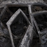 
              A charred car contains the remains of two people after Russian bombardment in Kharkiv, Ukraine, Thursday, April 21, 2022. Ukraine's second-largest city, has been under sustained Russian attack since the beginning of the war in late February. (AP Photo/Felipe Dana)
            