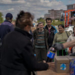 
              People queue to receive food donations in Kharkiv, eastern Ukraine, Thursday, May 19, 2022. (AP Photo/Bernat Armangue)
            