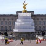
              Building work in preparation for the Platinum Jubilee celebrations take place in front of Buckingham Palace in London, Friday, May 6, 2022. Britain's Queen Elizabeth II acceded to the throne on the death of her father King George VI on Feb. 6, 1952, and the Platinum Jubilee bank holiday weekend celebrations will take place on June 2-5. (AP Photo/Kirsty Wigglesworth)
            
