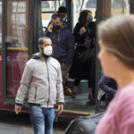 
              People wear face masks as they step off a public transport bus in Rome, Sunday May 1, 2022. Face masks, for the first time since the start of the pandemic, are no longer required in supermarkets, bars, restaurants, shops and most workplaces throughout Italy, but remain mandatory on public transport, planes, trains and ships, theatres, cinemas, concert halls and for indoor sporting events. (AP Photo/Gregorio Borgia)
            