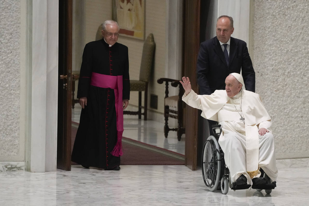 Pope Francis arrives in a wheel chair in the Paul VI hall to attend an audience with pilgrims from ...